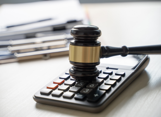 Gavel and calculator on desk